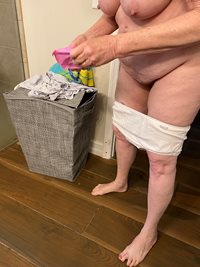 My naked wife Kay applying a panty liner.