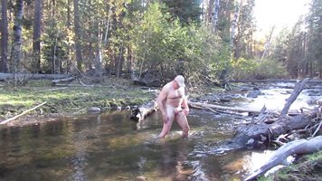 Naked stroking it in the river.