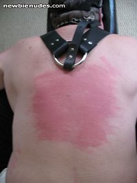Mistress A's sub-boy receiving Her heavy flogger on back