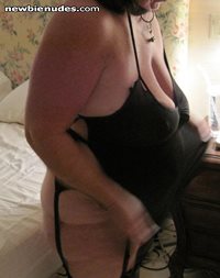 Slut putting on her little black mini dress.