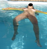 My wife's shaved pussy in pool