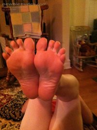 My wife got a pedicure then rubbed lots of lotion on her feet before puttin...
